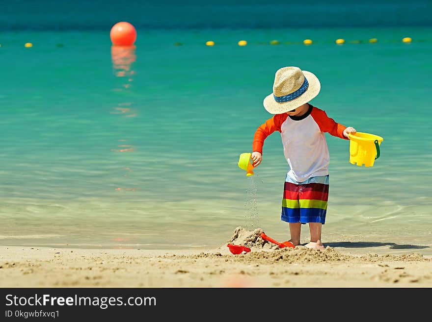 Two Year Old Toddler Playing On Beach