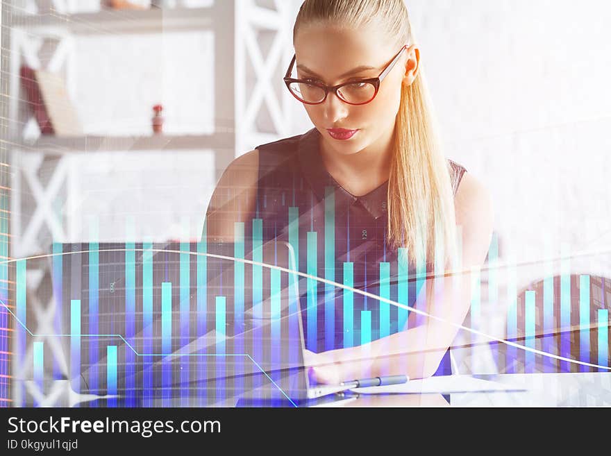 Portrait of attractive young european businessman using laptop in modern office with forex chart. Fund management and stock concept. Double exposure