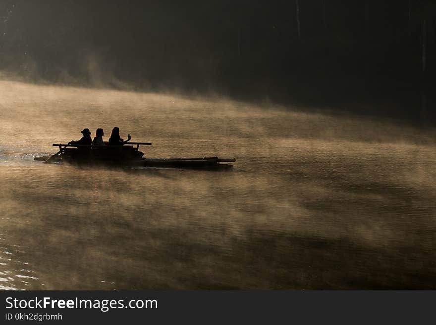 Silhouette of bamboo rafting on the lake in morning.