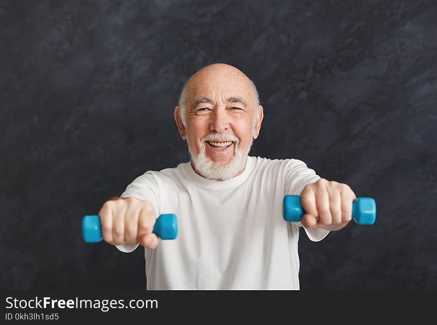 Senior Man Making Exercise With Dumbbells