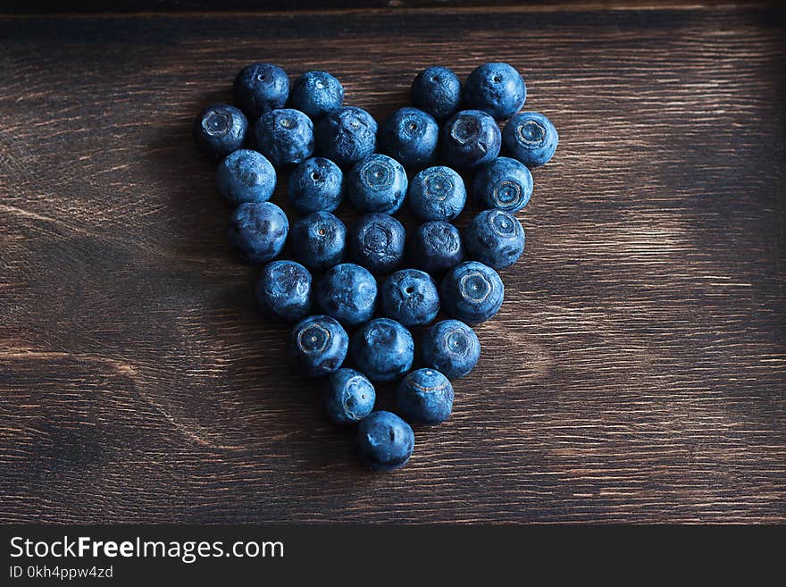 Blueberry ripe wooden background.