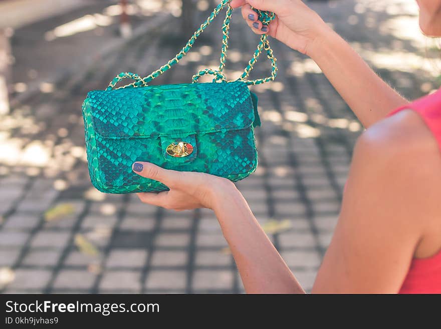 Photo of Woman Holding Blue Crossbody Bag