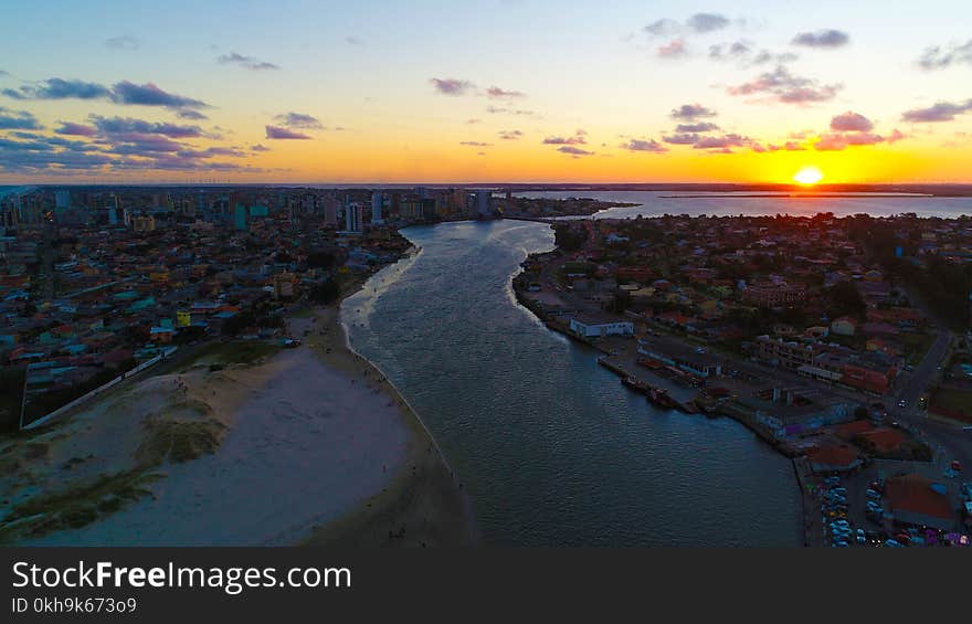 Buildings Near Body of Water during Sunset