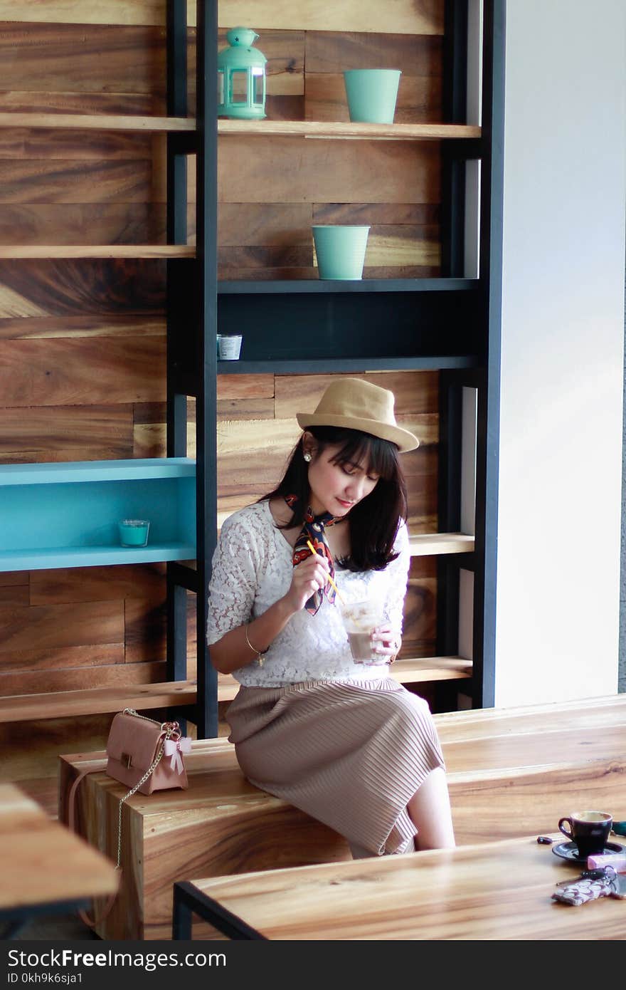 Photo of Woman Sitting on Wooden Chair