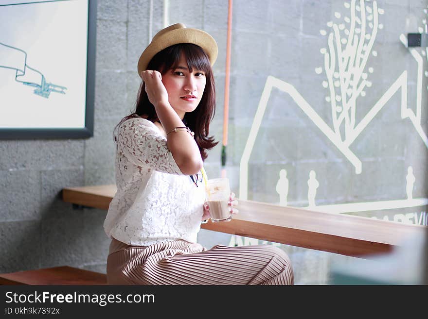 Photography of a Woman Sitting on Bench