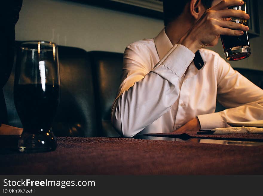 Photography of a Man Holding Drinking Glass