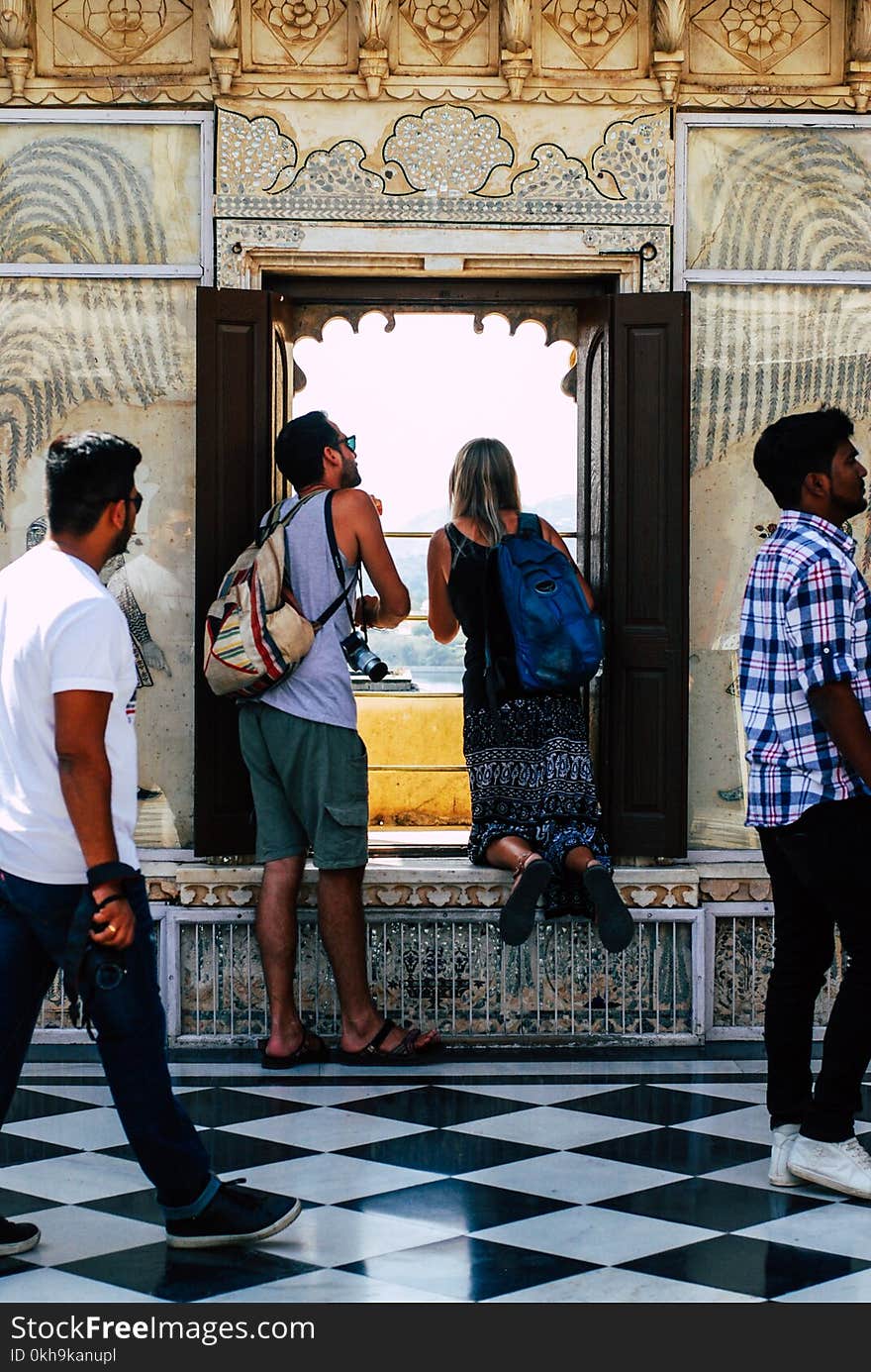 Photo of Man and Woman Looking at the Window