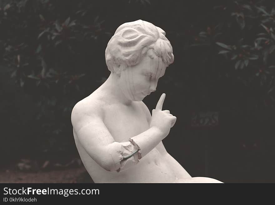 Close-up Photography of Boy Statue