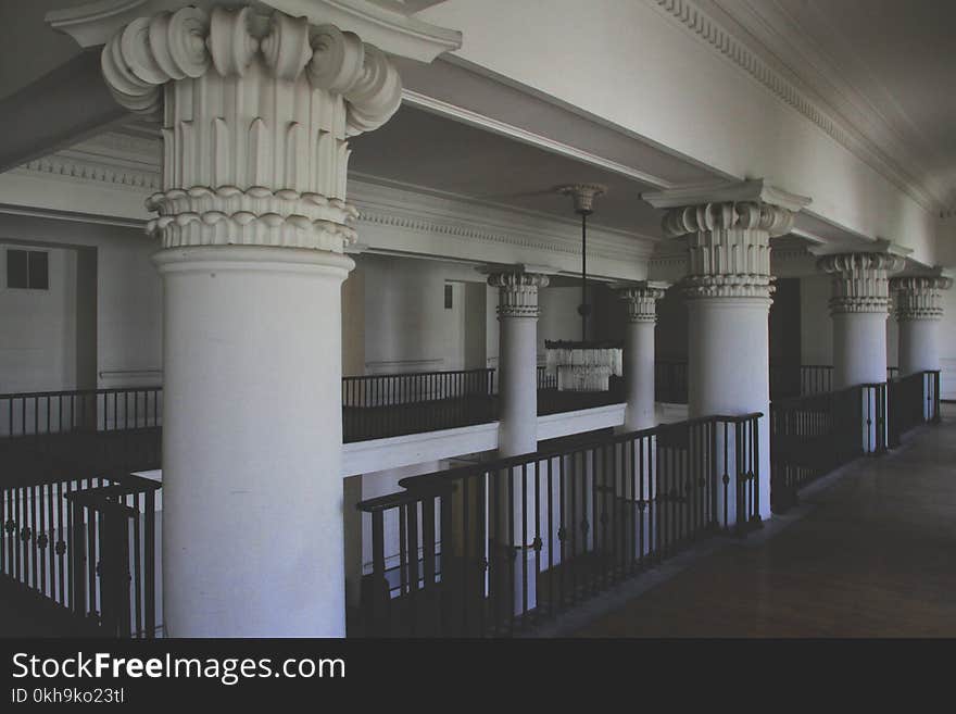 Photo of White Columns Near Railings