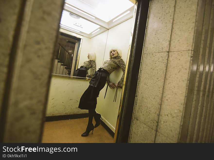 Photography of a Woman on Elevator