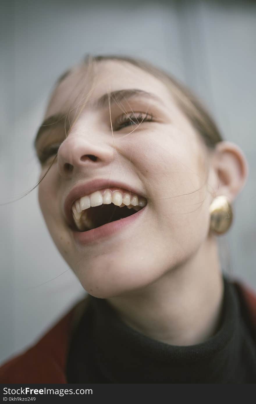 Close-Up Photography of a Laughing Woman