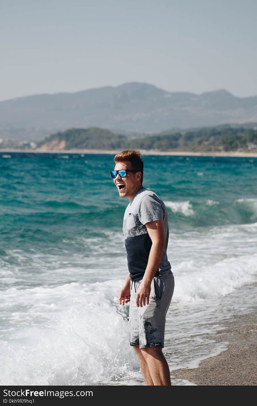 Photography of a Man Standing on Seashore