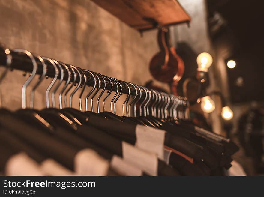 Photo of Black Clothes on Hangers