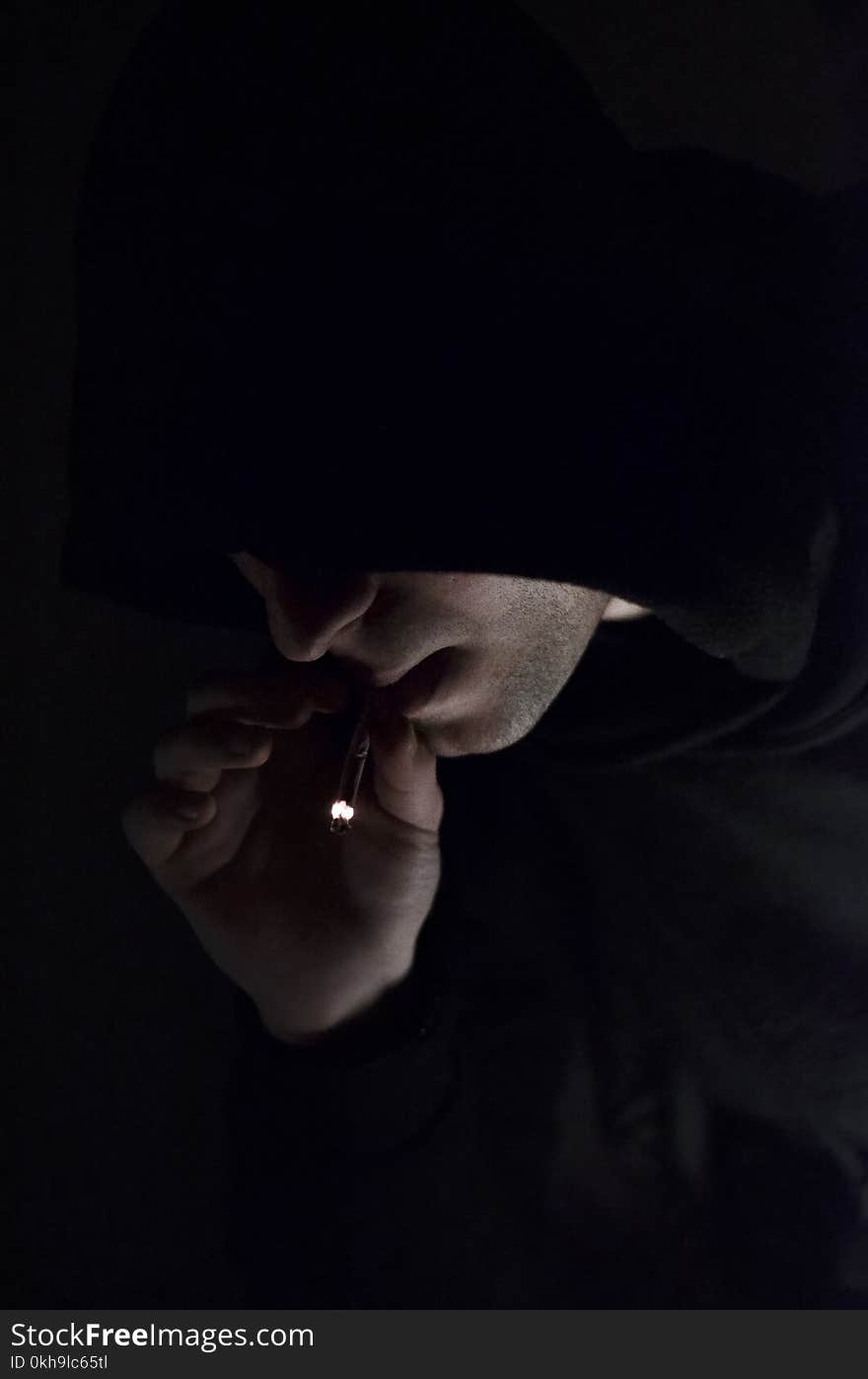 Man in Hoodie Smoking Cigarette