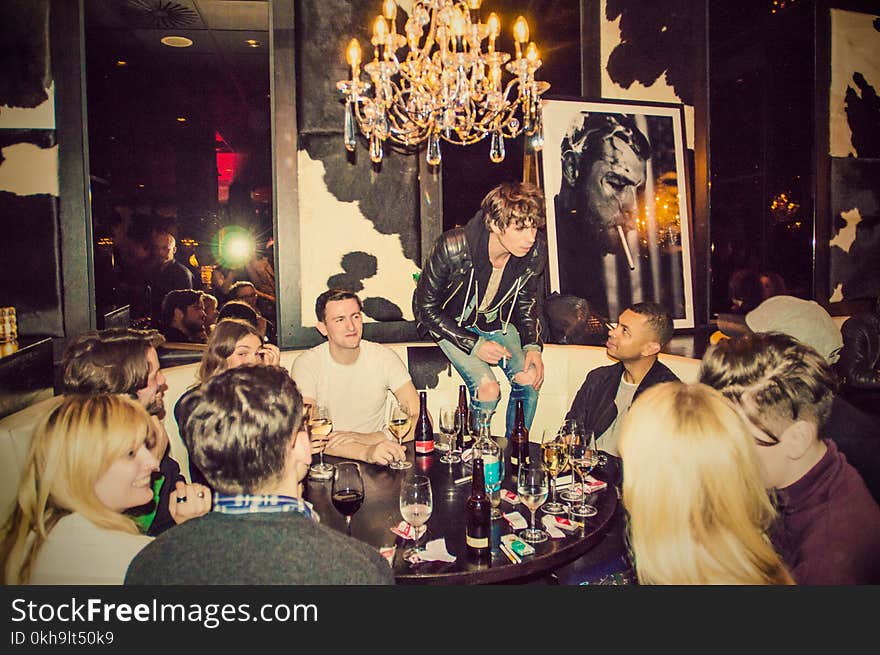 People Sitting Around Black Wooden Table