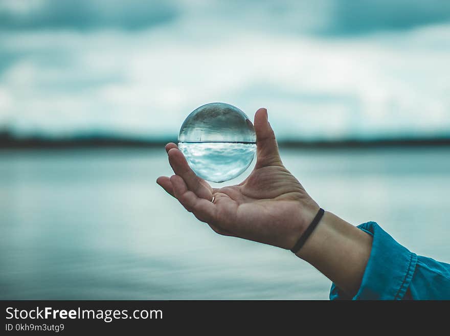 Person Holding Crystal Ball