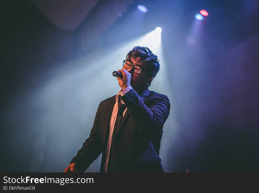 Man Holding Microphone on Stage