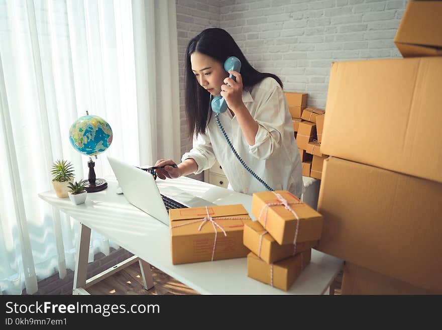 Woman Wearing White Dress Shirt Using Blue Telephone