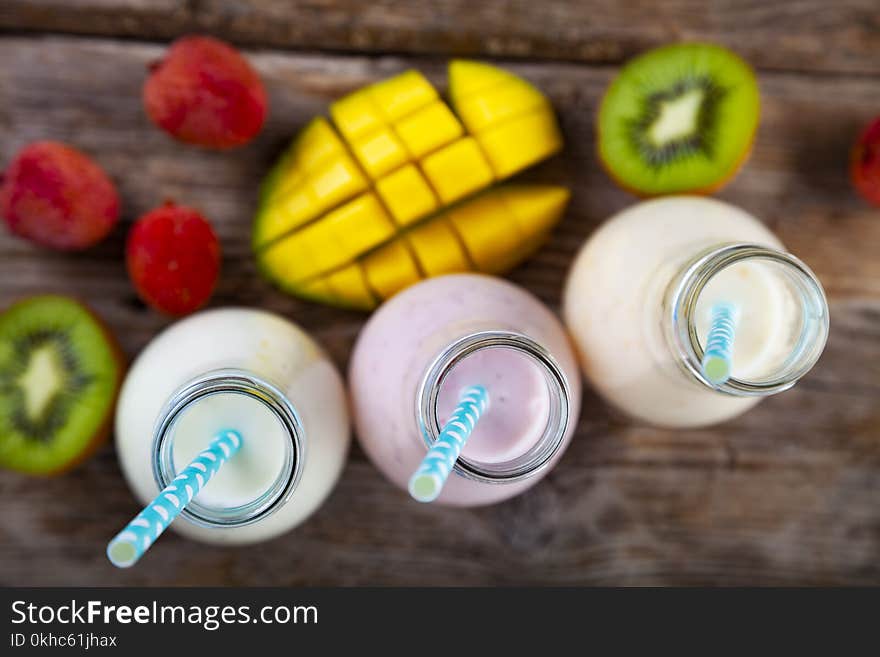 Smoothies with tropical fruits on a wooden background. Tasty breakfast. Healthy eating.