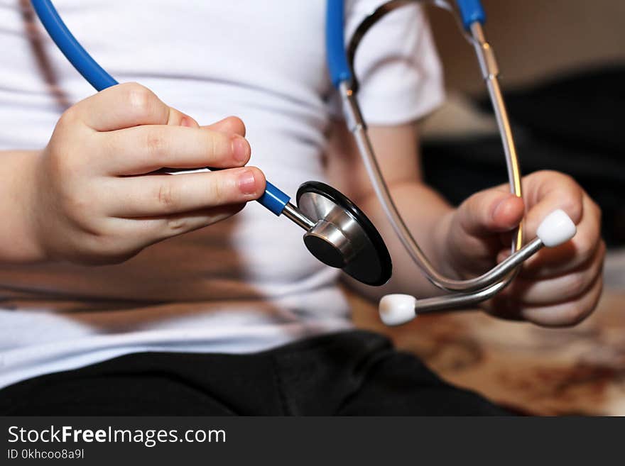 Medical instruments stethoscope in hands of baby boy