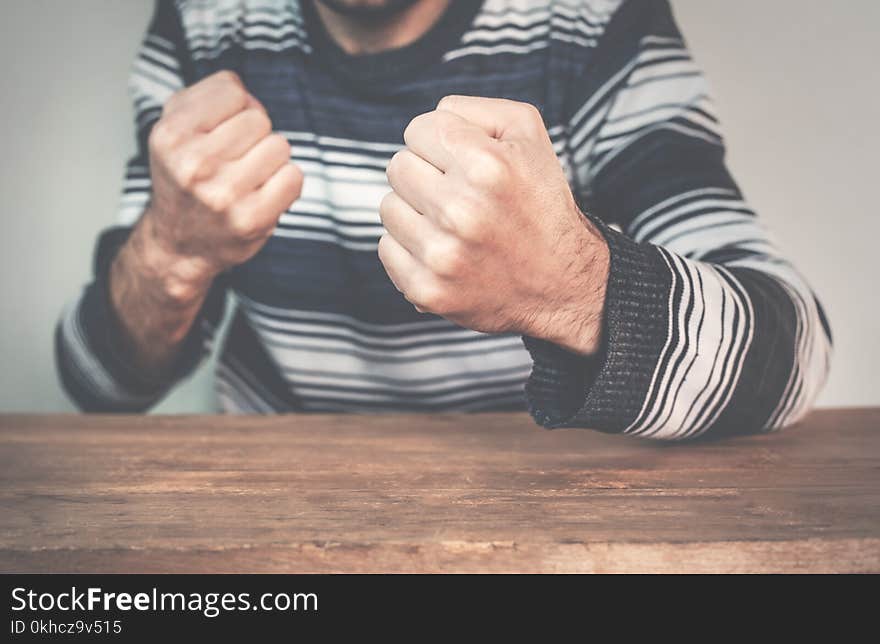 Caucasian man doing fight gesture.