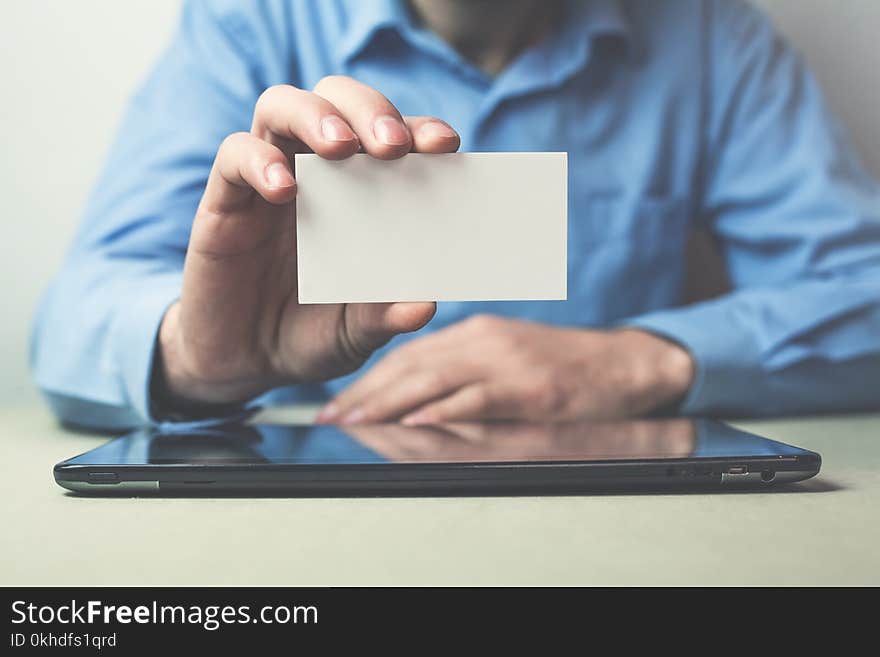 Businessman Showing A Business Card In His Business Desk.