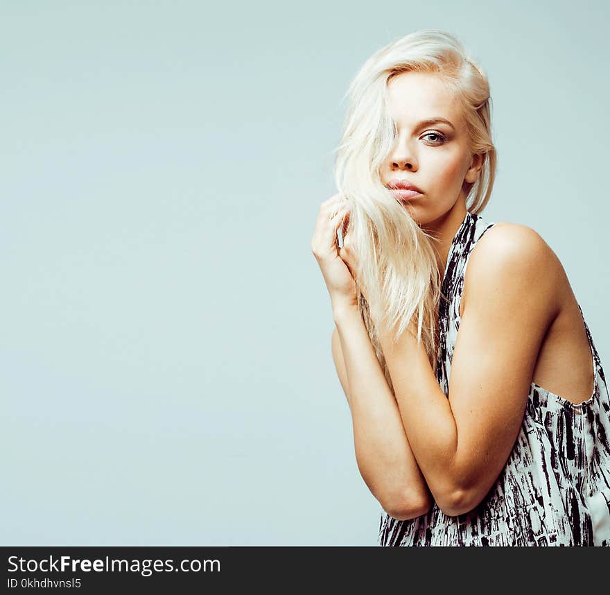 Young pretty stylish blond hipster girl posing emotional on white background happy smiling cool smile, lifestyle people concept close up. Young pretty stylish blond hipster girl posing emotional on white background happy smiling cool smile, lifestyle people concept close up