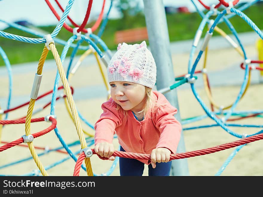 Active Little Girl On Playground