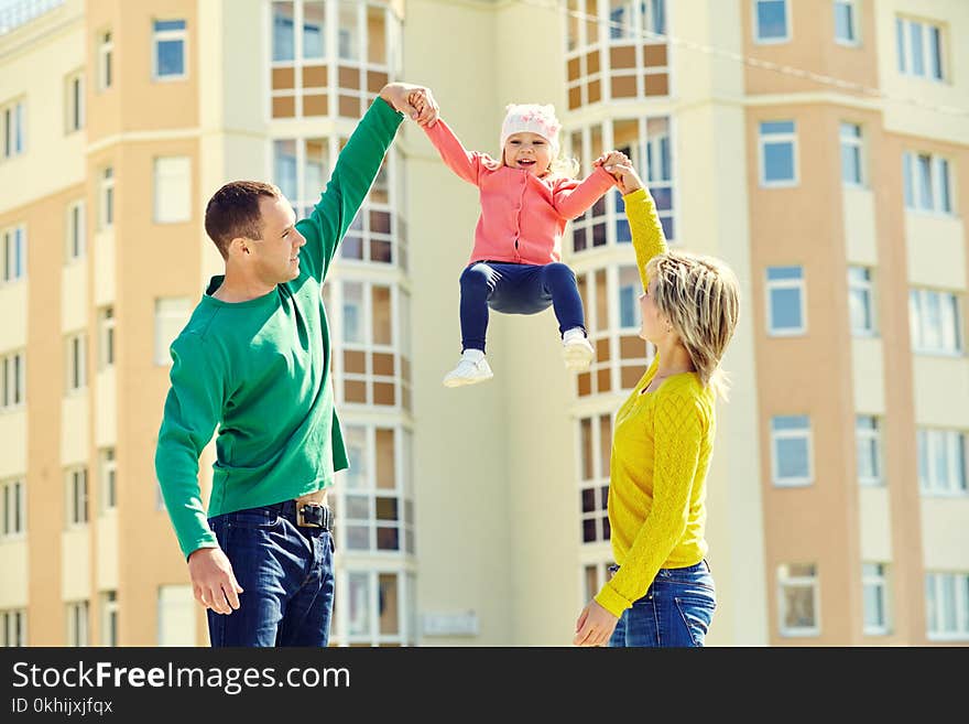 Happy playing family outdoors. young parents with a baby for a walk in the summer. Mom, dad and child. Happy playing family outdoors. young parents with a baby for a walk in the summer. Mom, dad and child