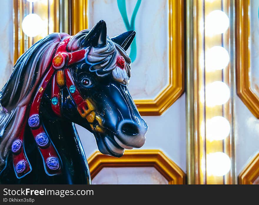 Colorful Horse carousel in Luna Park. Horse merry-go-round, vintage childhood background.