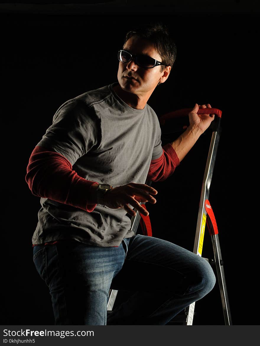 The brunette man poses for a stylish photograph indoors. The brunette man poses for a stylish photograph indoors.