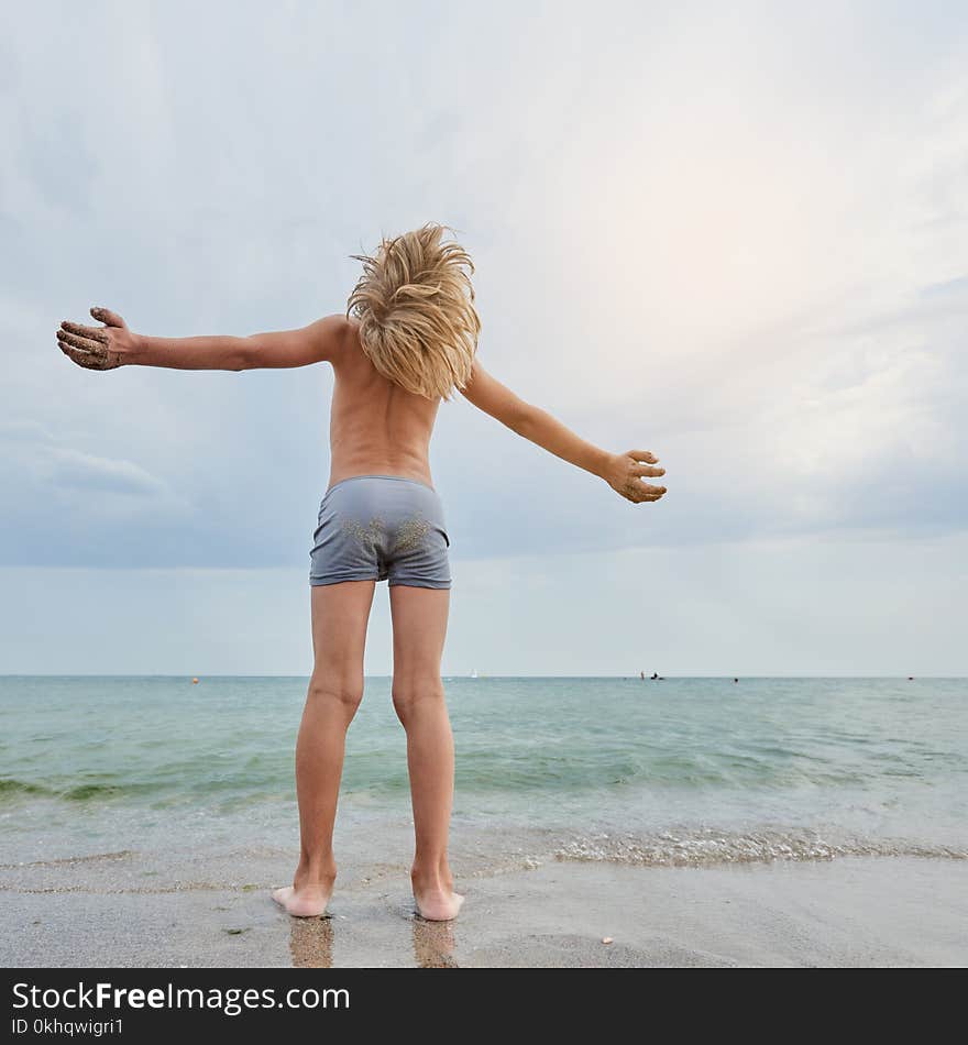 Boy Enjoying The Sea