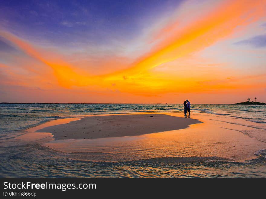 Two People Standing Near Seashore