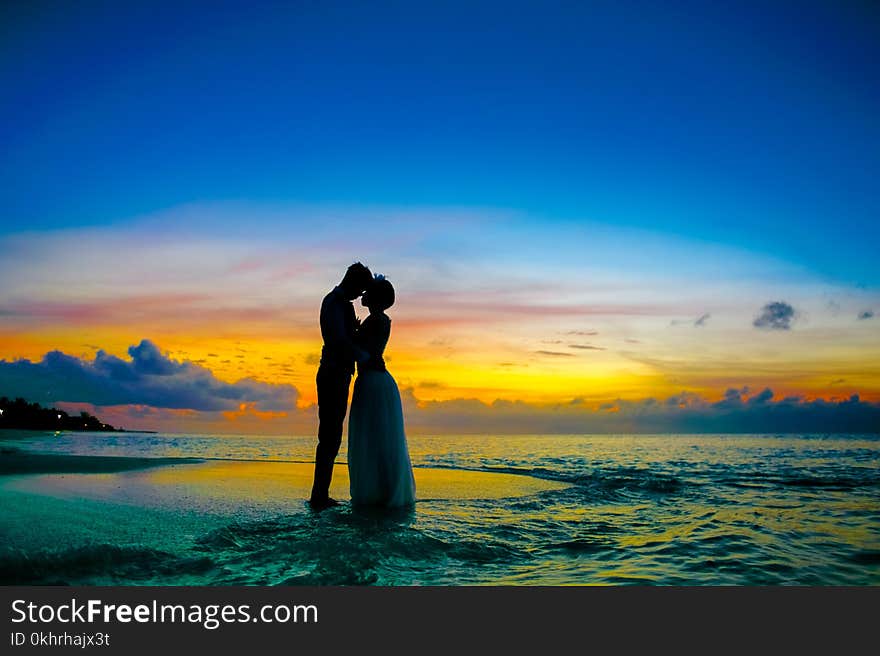 Man and Woman Standing at Seashore