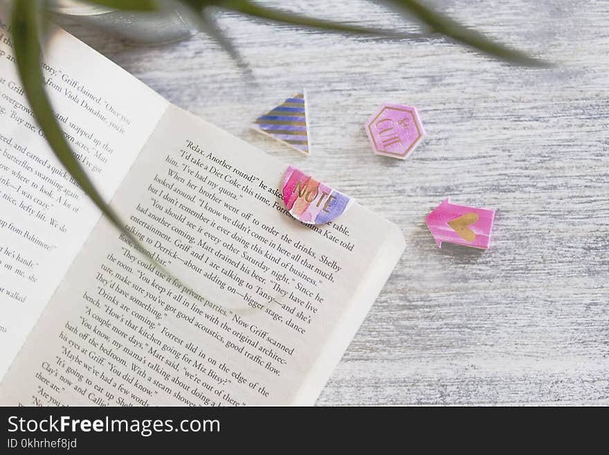 Opened Book With Pink Note Bookmark