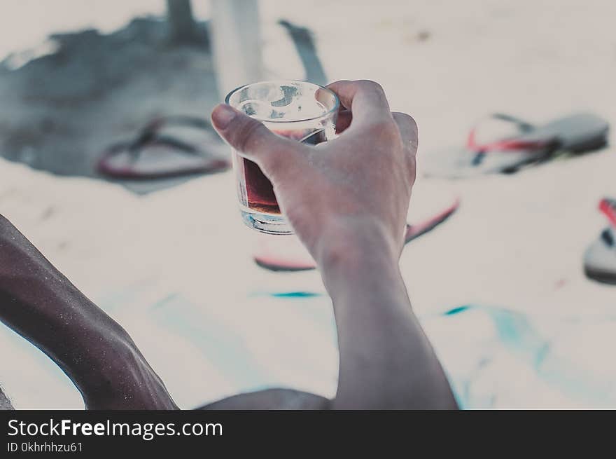 Person Holding Clear Old-fashioned Glass