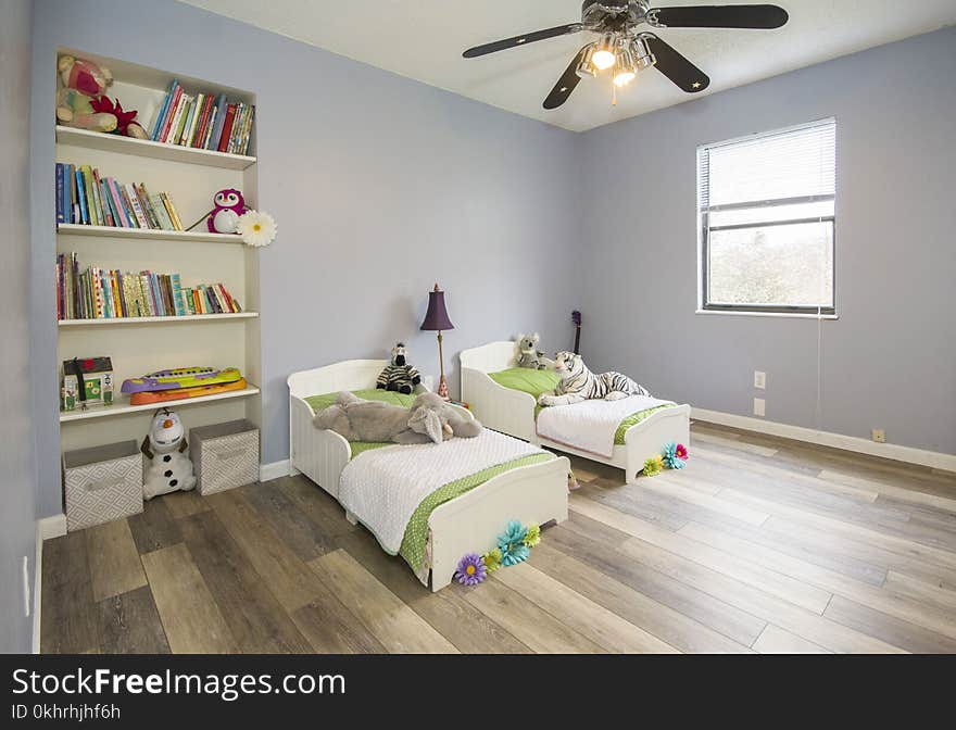 Two Single Beds Beside Books Shelf Inside Room