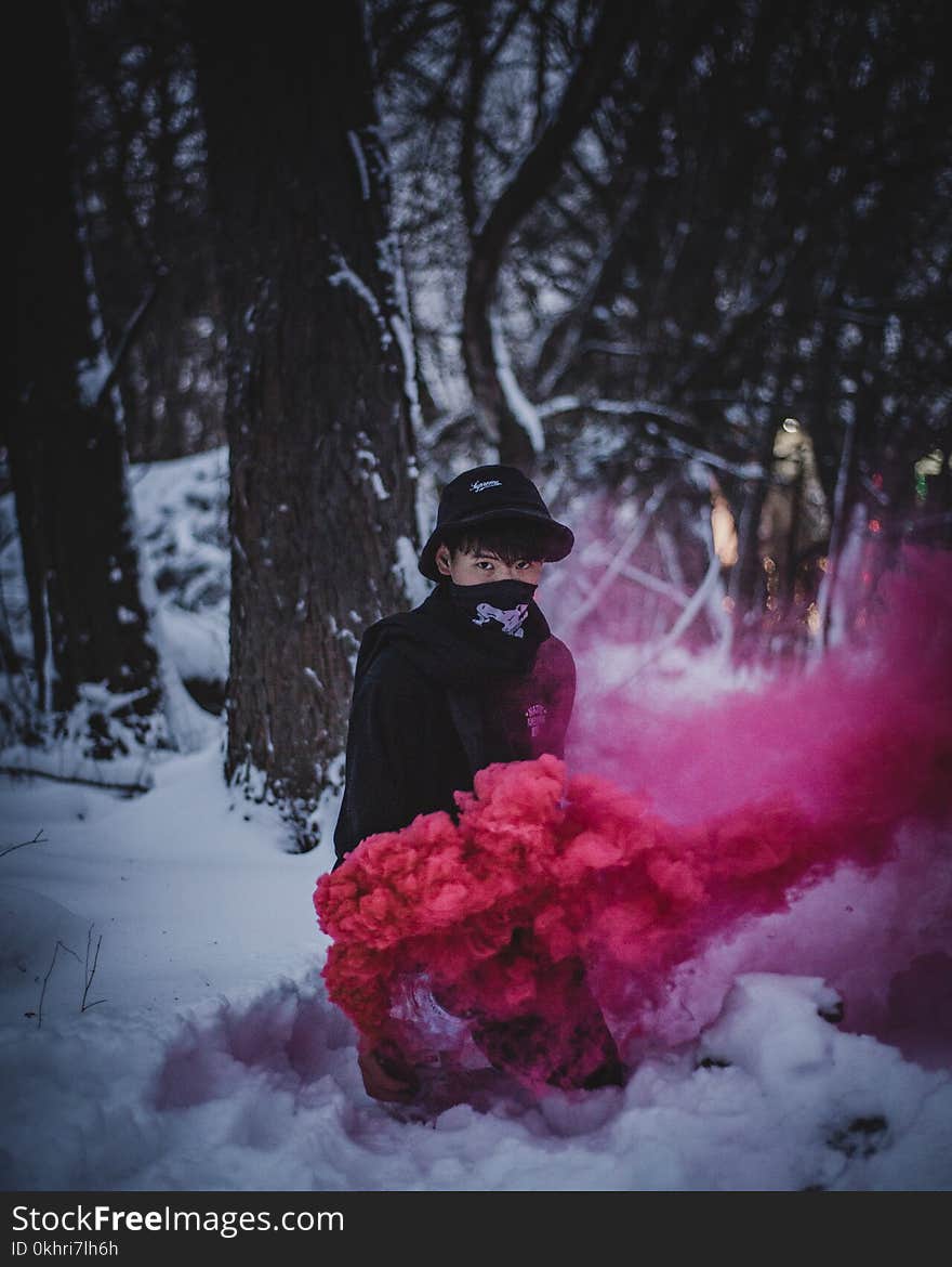 Photo of Man Surrounded by Red Smoke