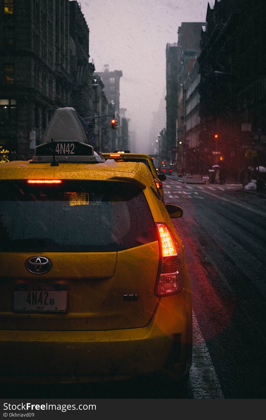 Close-Up Photography of Yellow Toyota Hatchback on Road