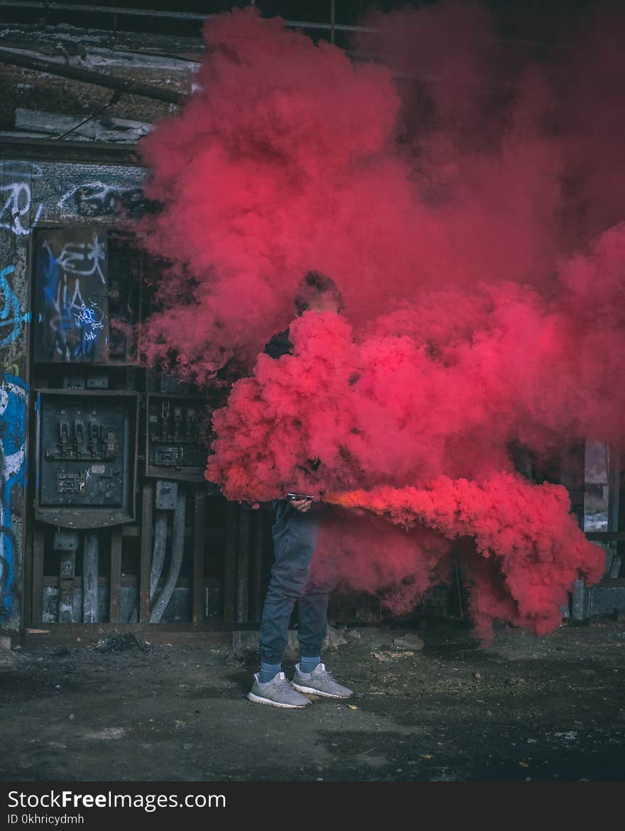 Photo of Man Surrounded by Red Smoke