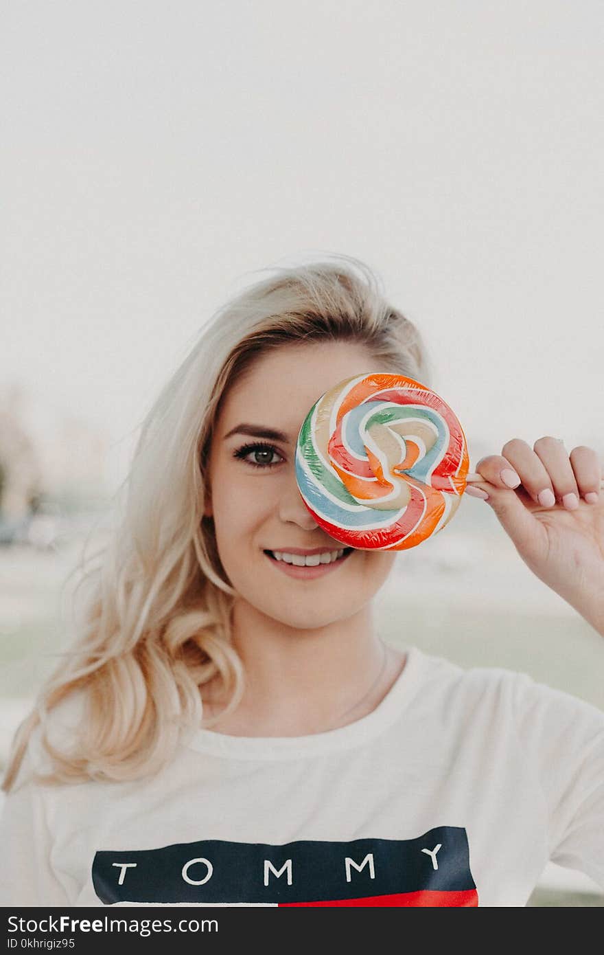 Close-Up Photography of a Woman Holding Lollipop