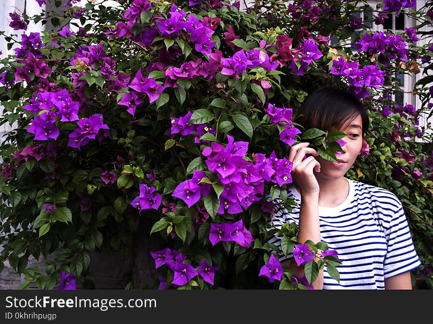 Close-Up Photography of Woman Near Purple Bougainvillea