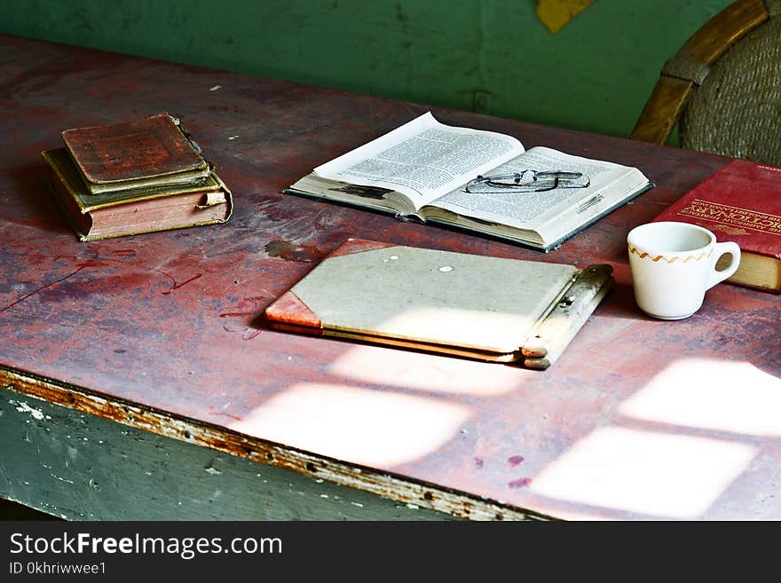 White Ceramic Mug Near Books