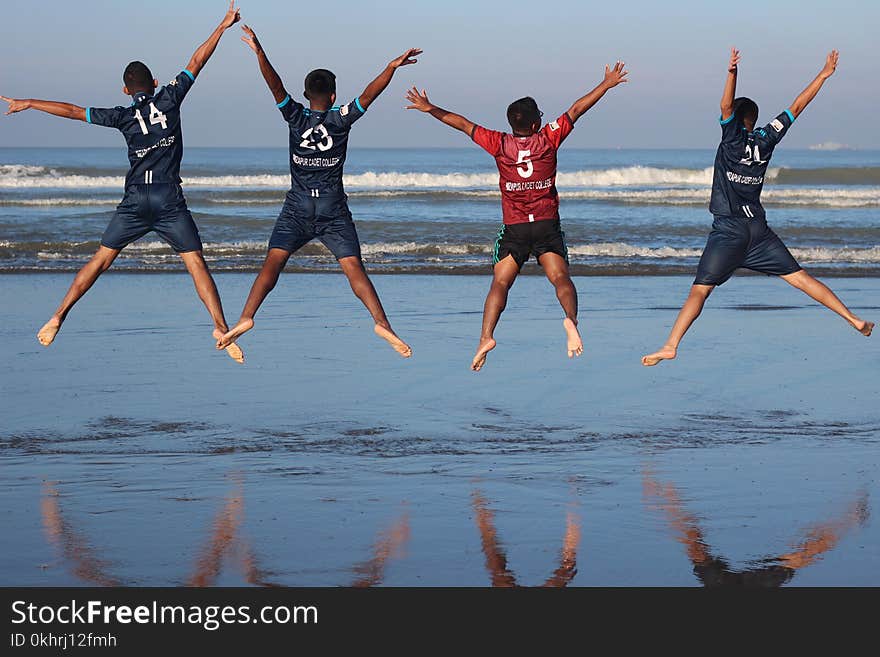 Photo of Four Men on Water