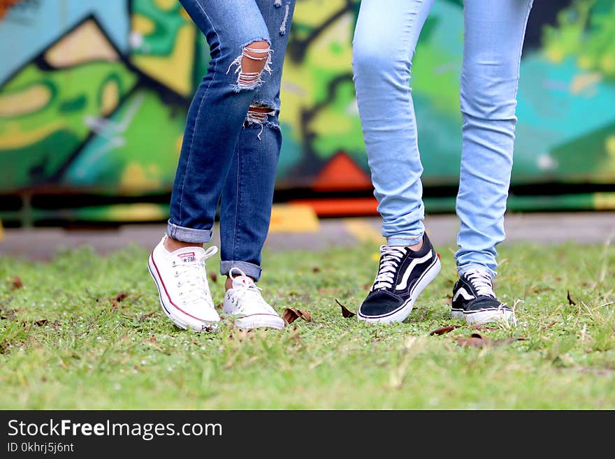 Person&#x27;s Wearing White and Black Low-top Sneakers