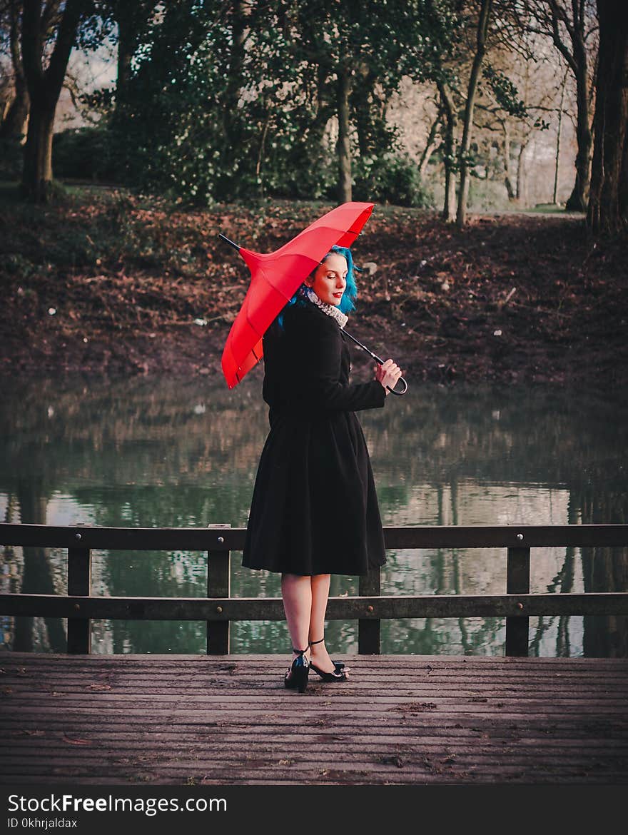 Woman Wearing Black Long-sleeved Dress Holding Red Umbrella