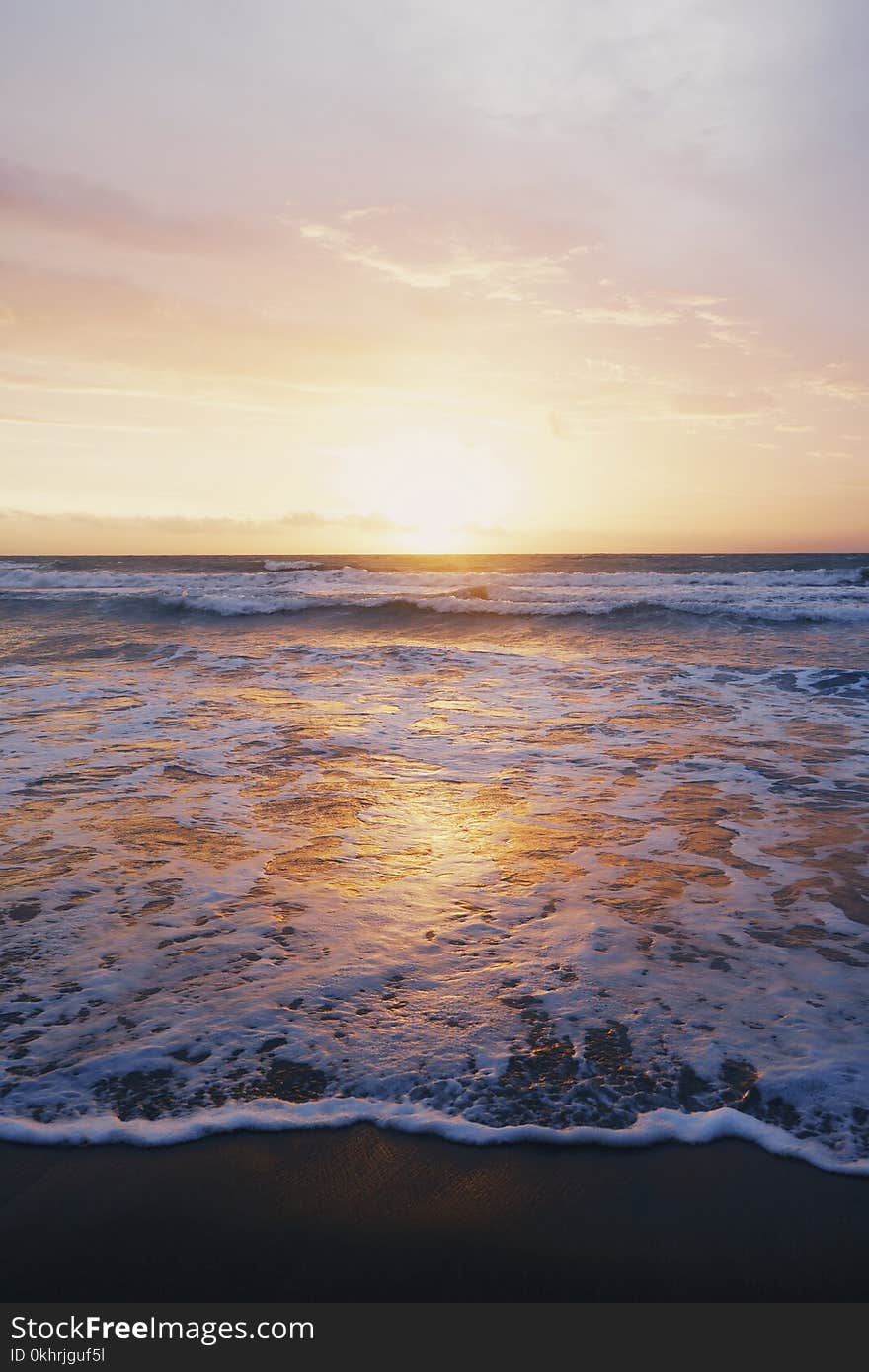 Photo of Ocean Waves Near Seashore during Sunset