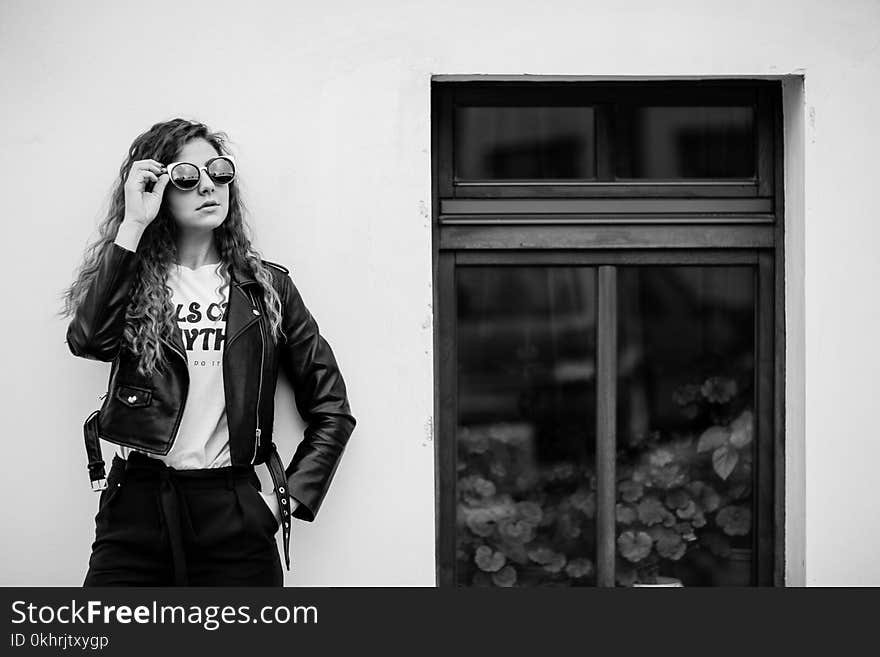 Gray Scale Photo of Woman Near Window