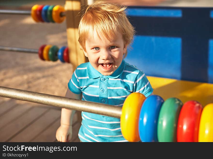 Cute little boy at playground area. Summer outdoor