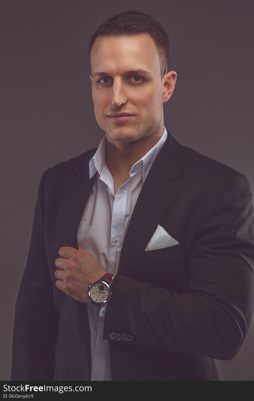 Elegant man in a suit isolated on a grey background. Elegant man in a suit isolated on a grey background.